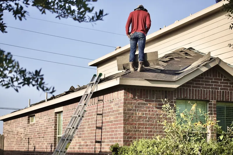 Professional roofer working on a residential roof in East Buffalo